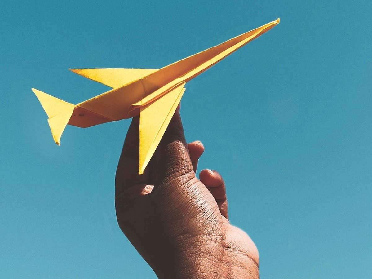 an intricately shaped paper plane, ready for take off