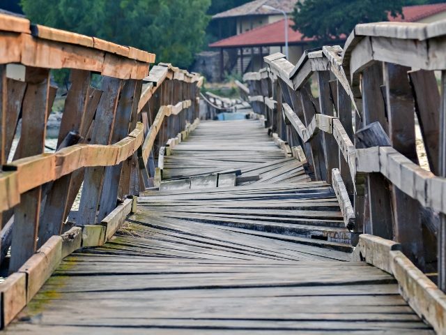 Wooden bridge with cracks, unevenness. 