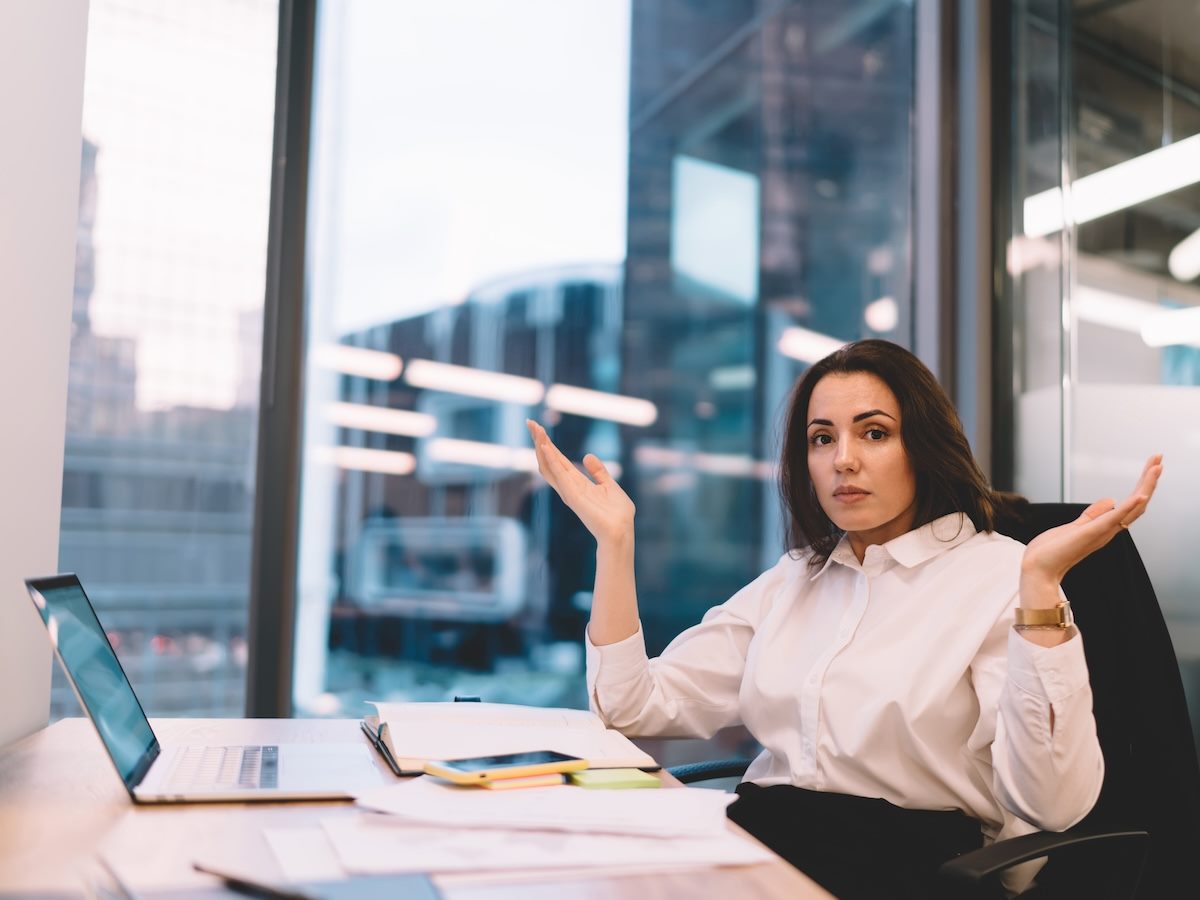 business woman shrugging, not understanding why someone would do something