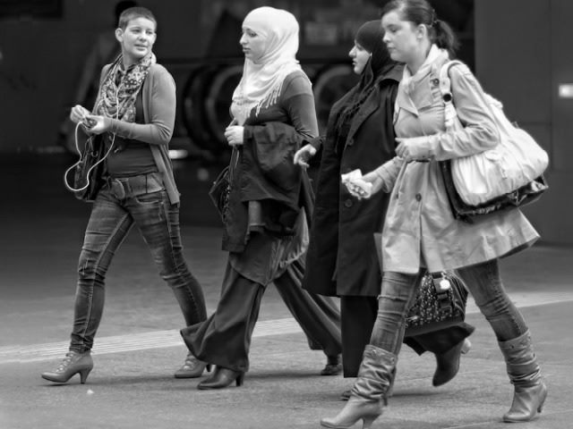 four women walking down a street