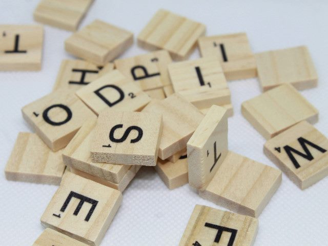 A pile of Scrabble letter tiles.