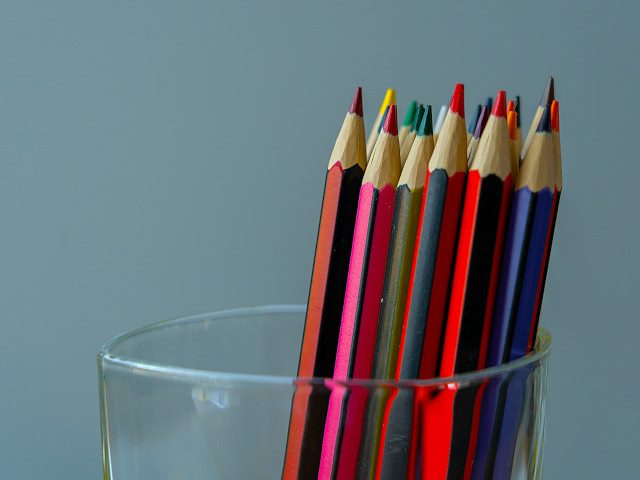 A glass of colored pencils.
