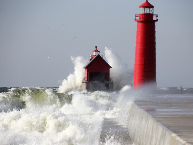lighthouse during daytime in rough seas
