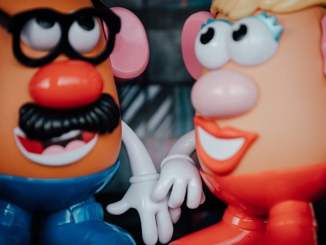 two toys facing each other: Mr and Mrs Potato Head 