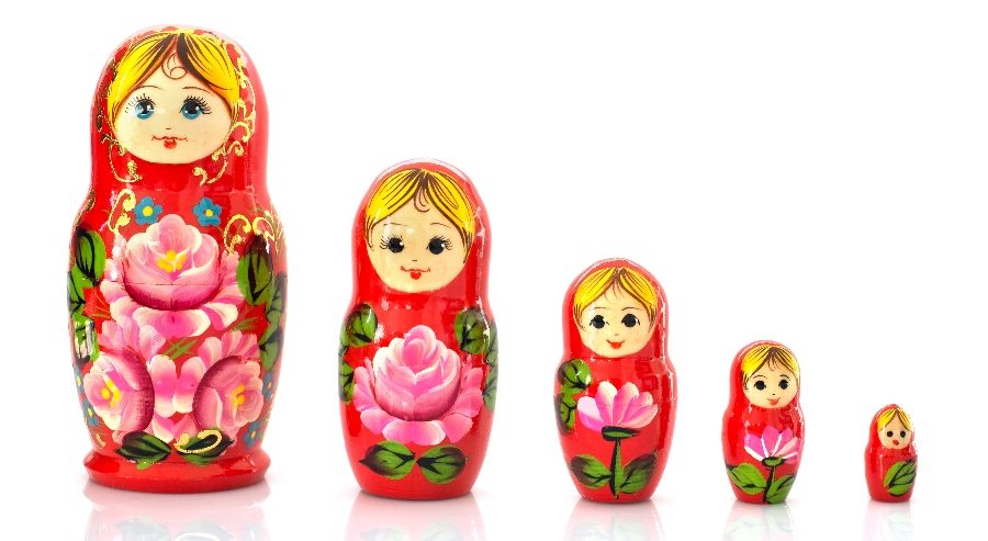 This image shows a set of five traditional Russian Matryoshka dolls, arranged from largest to smallest. Each doll is painted with vibrant red and features a floral design with large pink and yellow flowers. The dolls have cheerful faces with blue eyes and blonde hair, symbolizing the layering concept akin to the "ChatGPT-4o Mini release," which emphasizes compact efficiency in technology scaling down in size but not in capability.