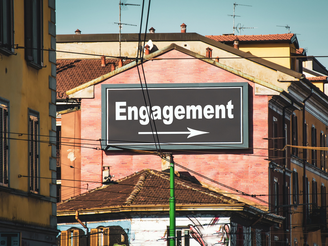 A city billboard/sign pointing the way to engagement