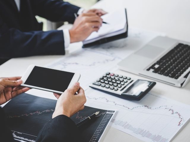 Business people working on funding charts 