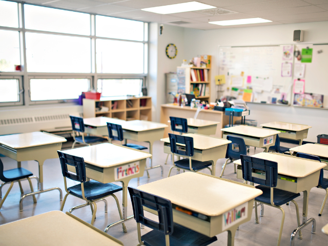 An empty classroom with desks and chairs 