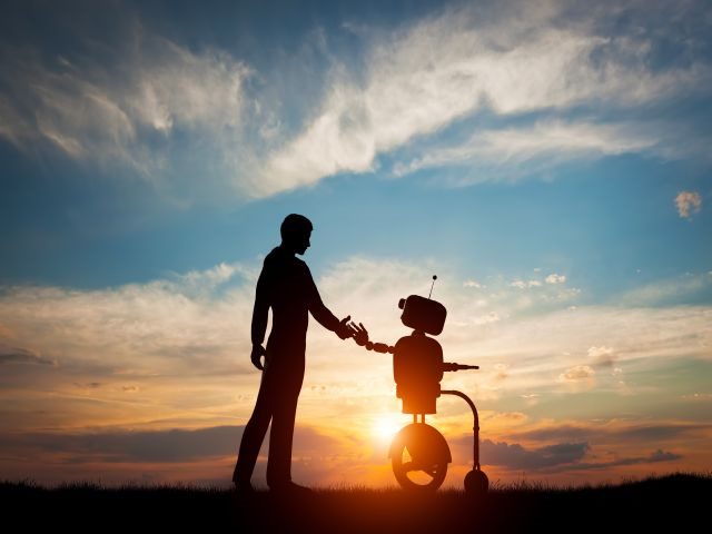 Future interaction with artificial intelligence, man and robot meet and handshake