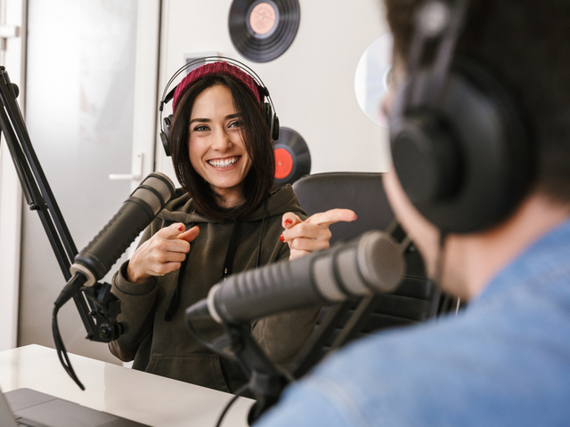 Two people in an office doing a podcast for their B2B audience - B2B marketing podcast concept