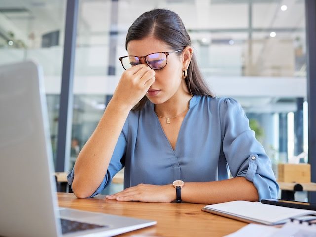 Stressed out woman at laptop