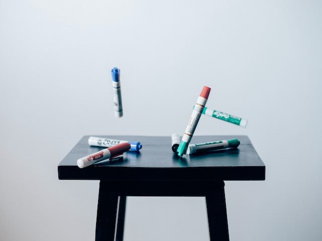 whiteboard markers bouncing off of a stool
