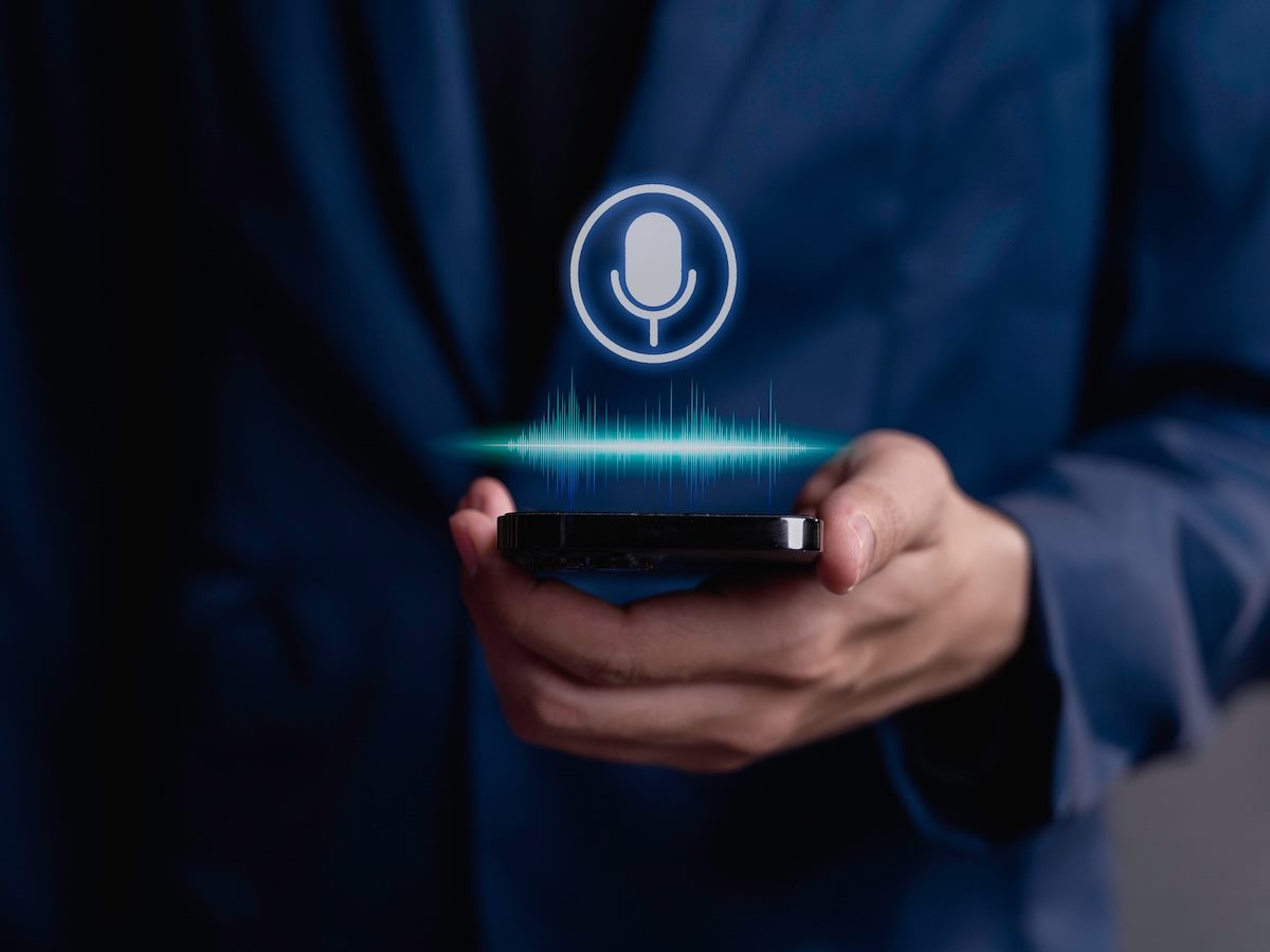 businessman using utilizes his smartphone as an AI assistant, effectively issuing voice commands