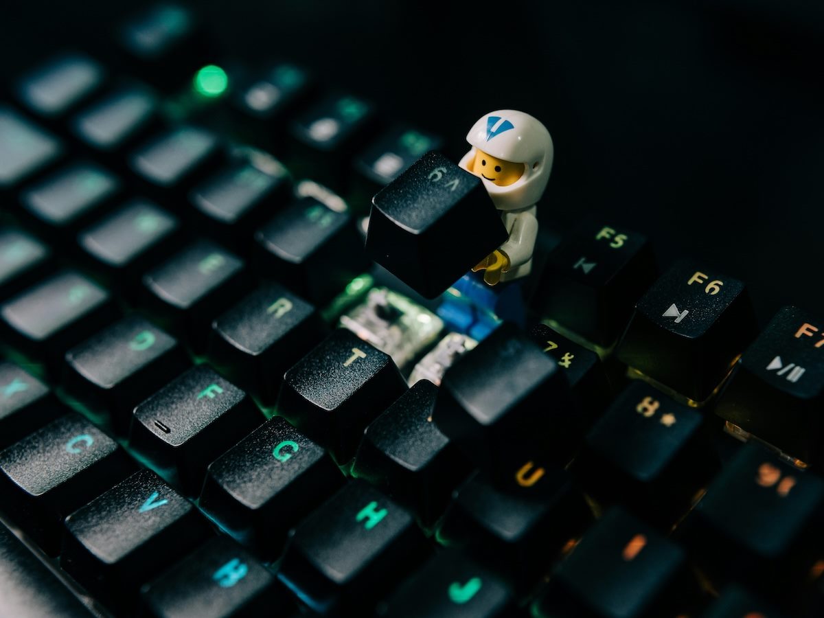 Lego figure fixing a computer keyboard 