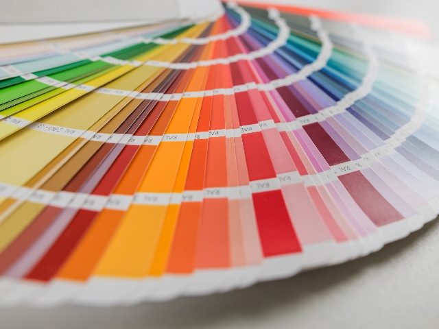 Fan of color paint samples for design.