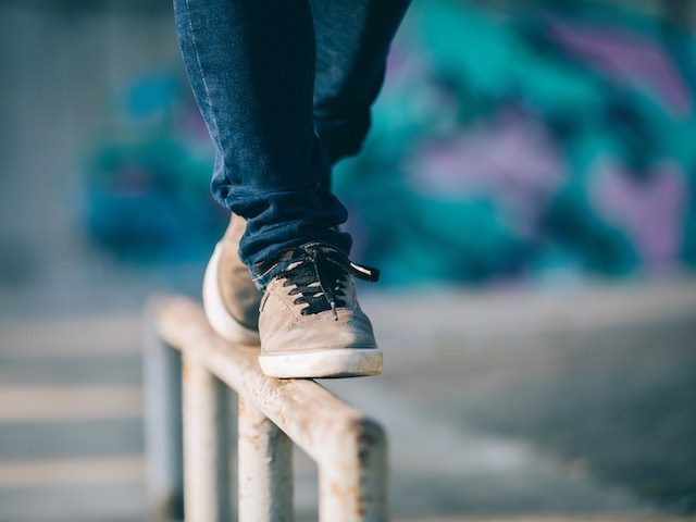 someone balancing on top of a fence