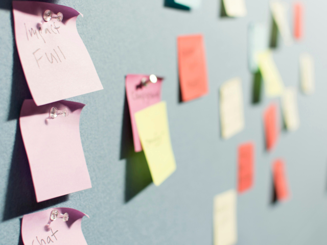A group of sticky notes pinned to a wall.
