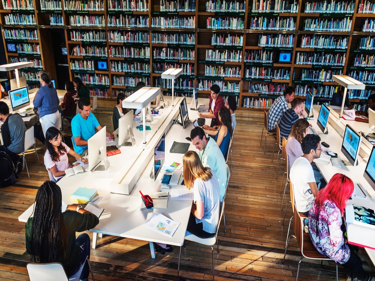 Students working on computers in a library setting