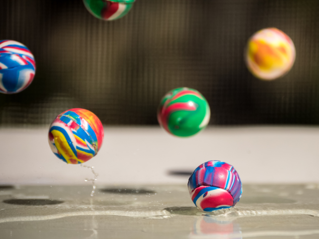 A bunch of high bounce balls bouncing off a wet countertop - Bounce Rate Concept