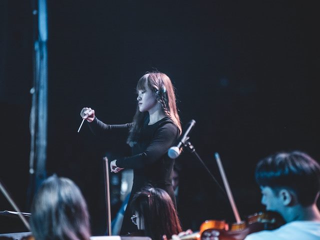 conductor leading an orchestra