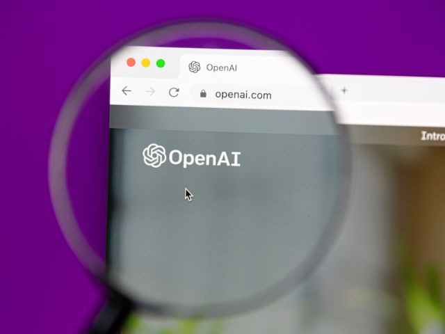 A magnifying glass looking at OpenAI's website. 