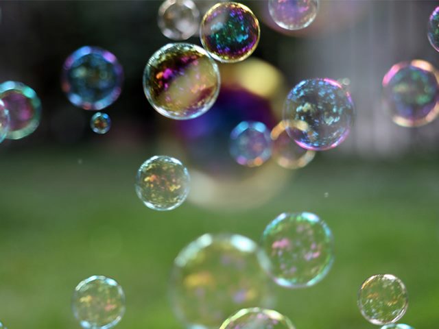 Bubbles floating appearing to be of rainbow descent. 