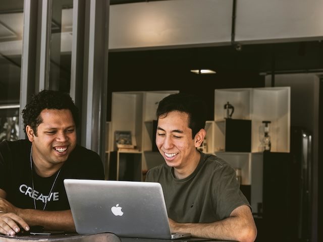two colleagues working together on a laptop  