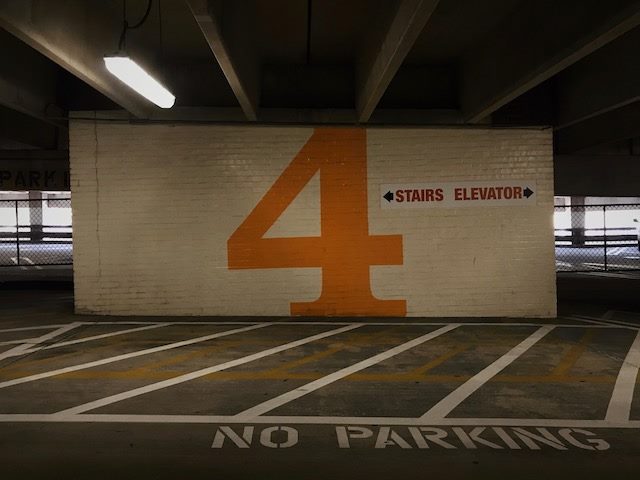 fourth level of a parking  garage, sign for stairs or elevator