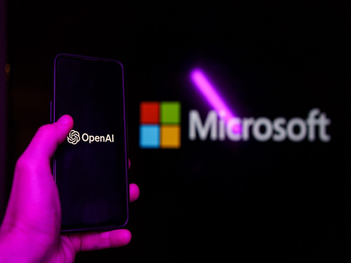 OpenAI logo and Microsoft logo in background displayed on the screens