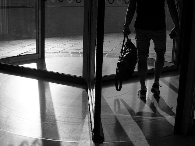 person walking through revolving door