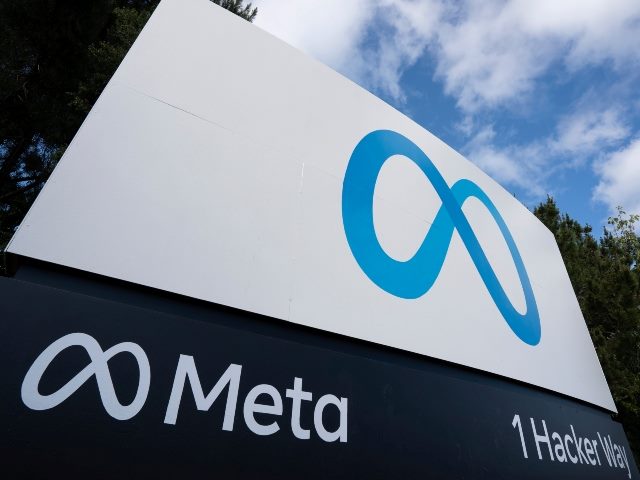 Closeup of the Meta sign with blue Meta logo at the entrance to the Meta Platforms headquarters in Menlo Park, California with address 1 Hacker Way at bottom