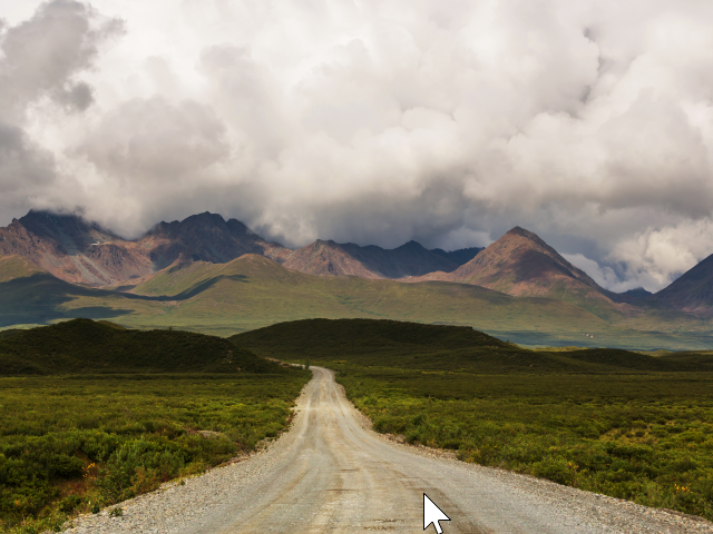 A road  that stretches on to the horizon, in the background are mountain peaks and clouds. A new frontier - The Denali Highway