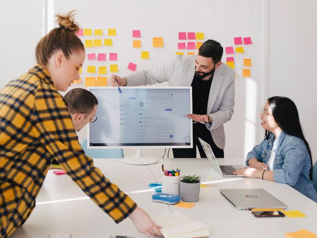 Employees training at a conference room table.