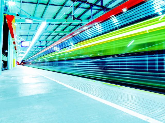 brightly colored train speeding by