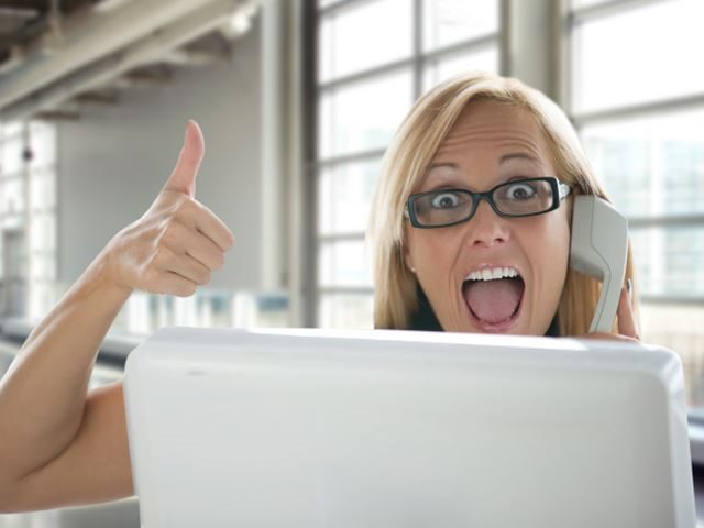 A happy customer using a laptop speaking with customer service on the phone - customer service concept