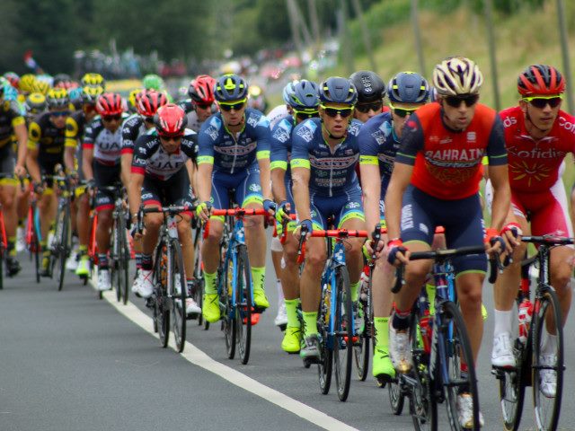 A group of cyclists on a race course.