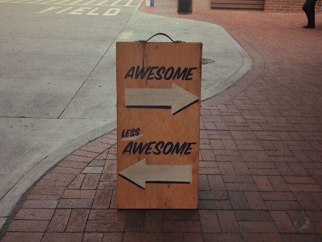 A sign that says "awesome" and "less awesome" with two arrows pointing in opposite directions