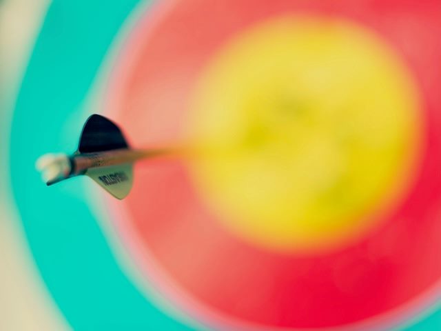 a dart in the middle of an abstracted target