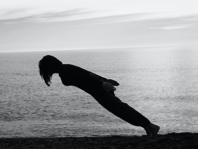black and white abstract photo of a person leaning into air with no support