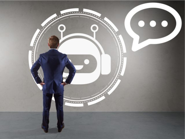 Businessman interacting with a chatbot, rendering on a wall