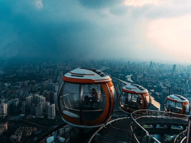 ride looking out over a city with cloudy skies on the horizon