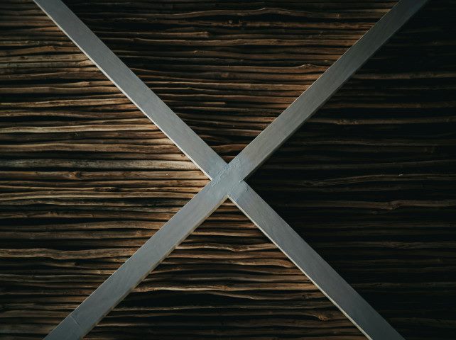 Metal X art on a ceiling.