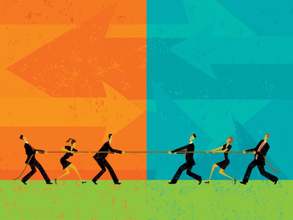 Six business people playing tug-of-war