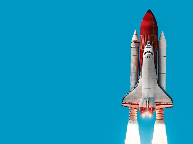 Space shuttle with red booster rockets up into the sky on blue background, suggesting the high impact of generative aI in marketing and sales. 
