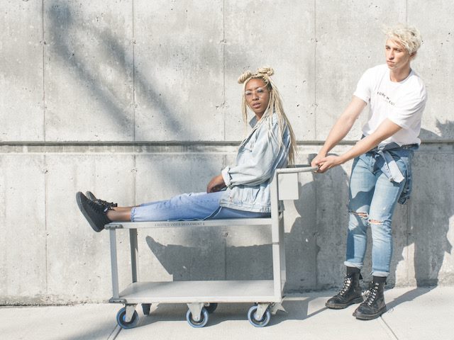 woman on cart being pulled by  a man