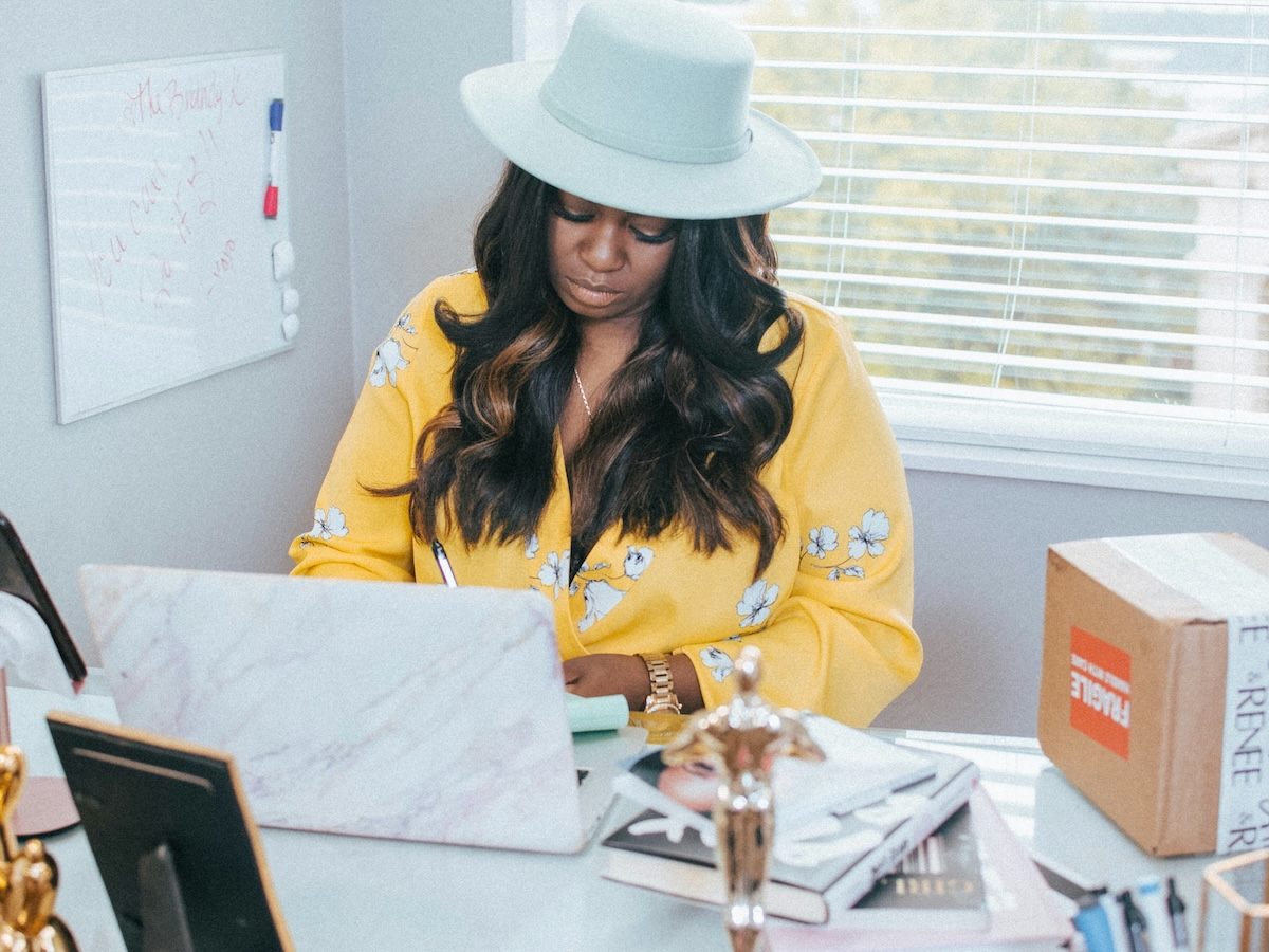 woman entrepreneur working at her desk, small business owner