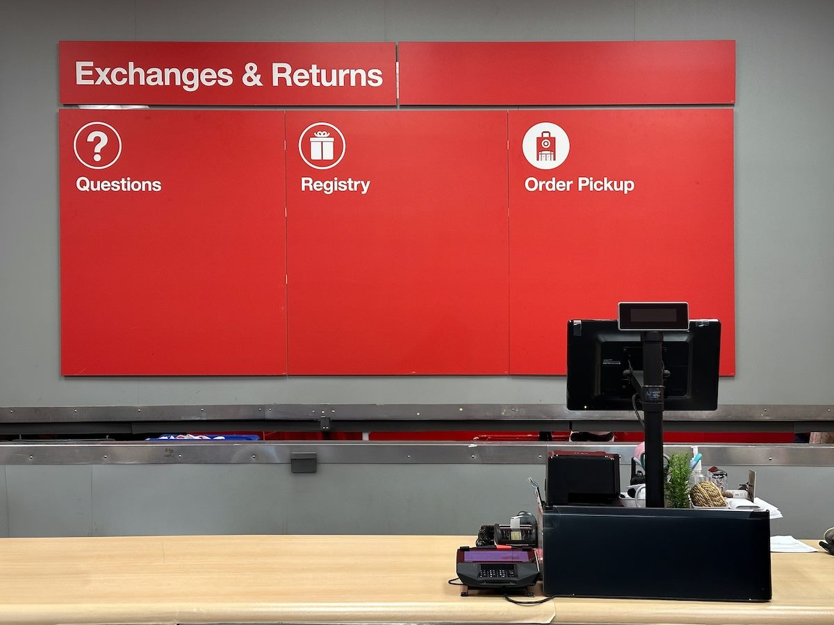 Customer service counter with a red signage board above it for exchanges, returns