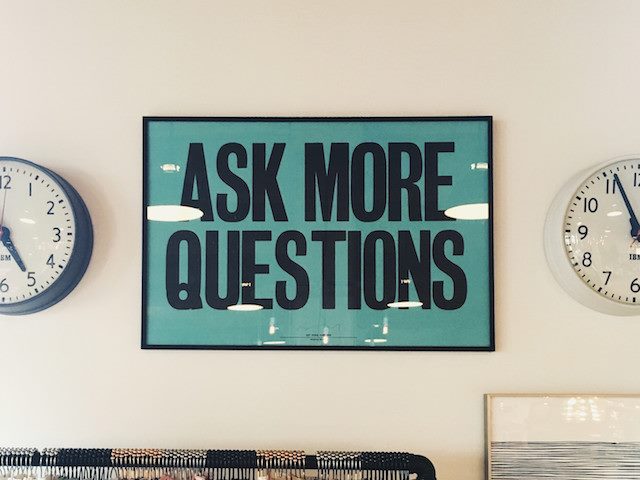 sign on a wall "ask more questions"