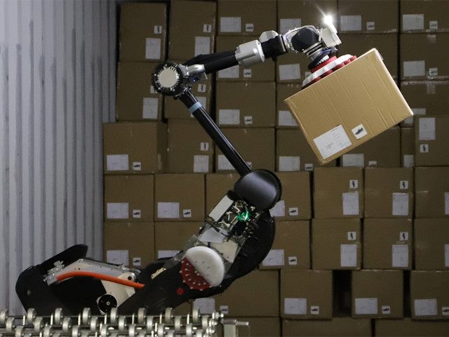 The Stretch robot by Boston Dynamics picks up a box in a warehouse.