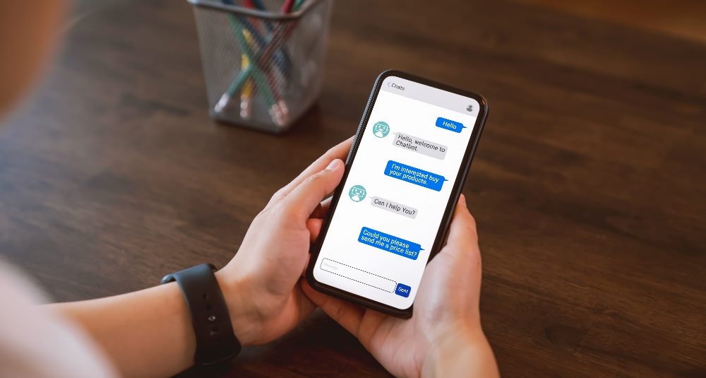 A customer is using his smart phone and communicating with a chatbot in piece about customer experience technology.